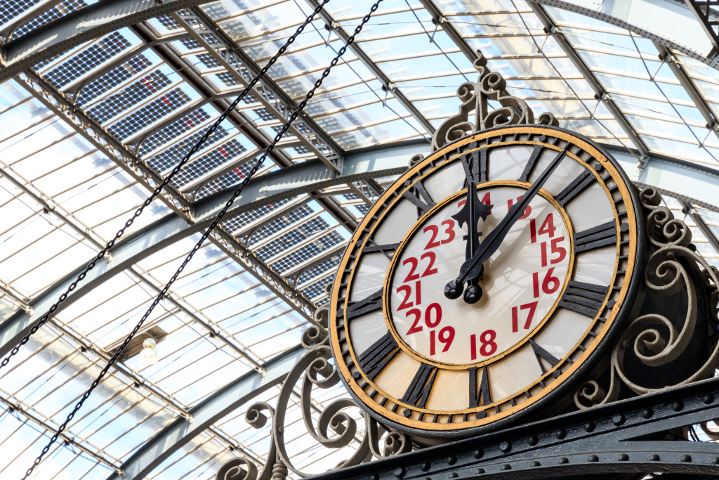 Old-fashioned style clock at Kings Cross train station in London
