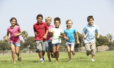 Group Of Children Running In Park