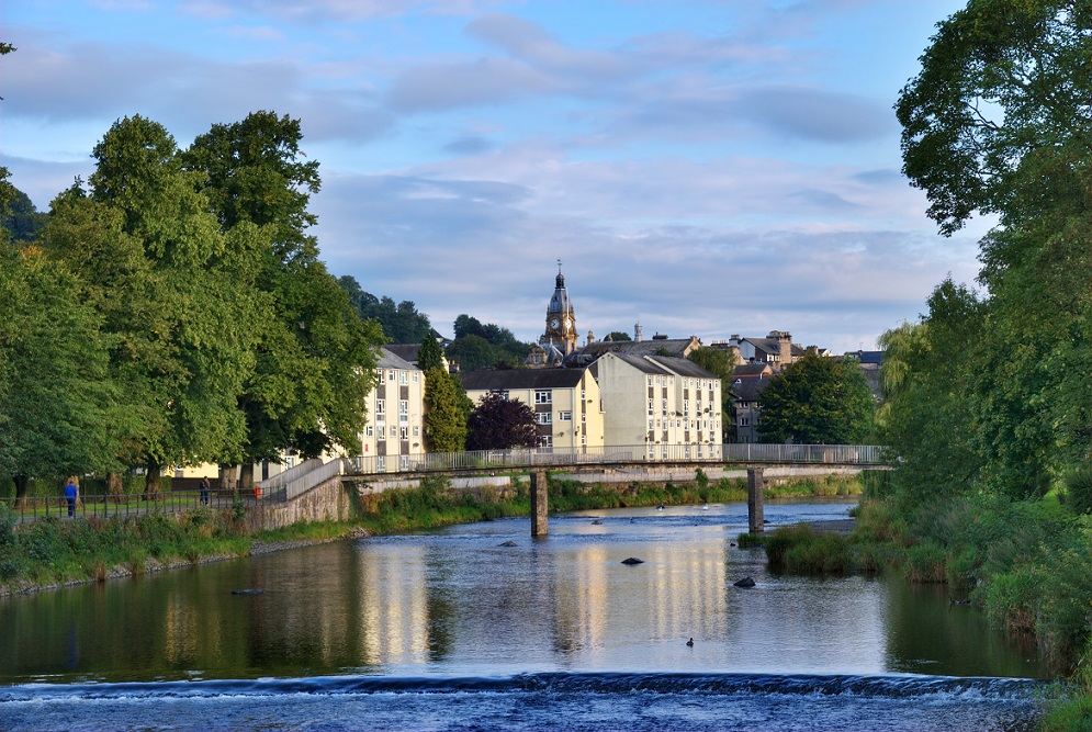 The River Kent, Kendal, Cumbria, England, with the clocktower of the Town Hall in the background