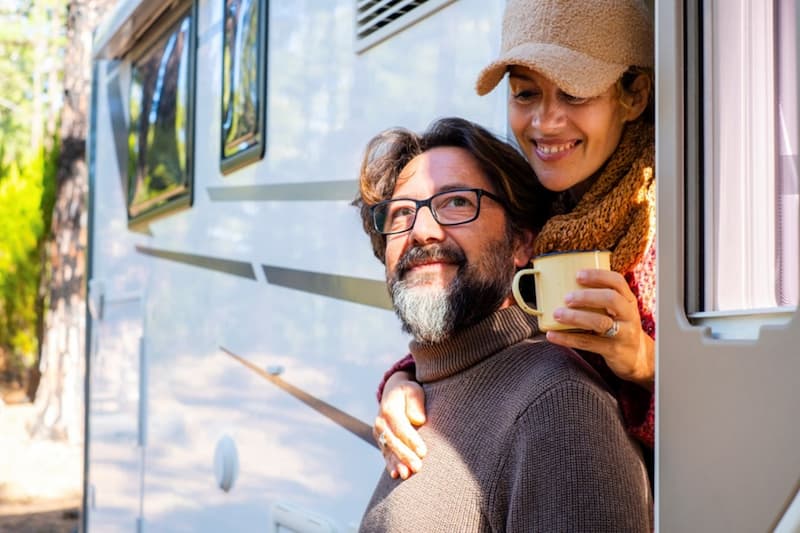 a couple enjoying a brew in a caravan
